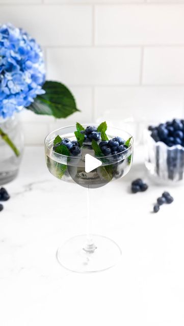 Jacqueline Murphy | Double the Spoonfuls on Instagram: "Bubbly Blueberry Hydrangeas! 🫐 A summery version of our strawberry rose cubes, with mint leaves and lemonade to freeze everything in place 🌊 Top with some prosecco and you end up with a lemony bubbly drink with lots of blueberries, perfect for summer days ahead! 🌿

#blueberries #hydrangeas #summertime #summerrecipes #mint #cocktails #refreshing #refreshingdrink #lemonade" Drink With Blueberries, Blueberry Mint Ice Cubes, Blueberry Ice Cubes, Blueberry Mint, Party Punch Recipes, Strawberry Roses, Summer Cocktail Recipes, Fancy Drinks, Boozy Drinks