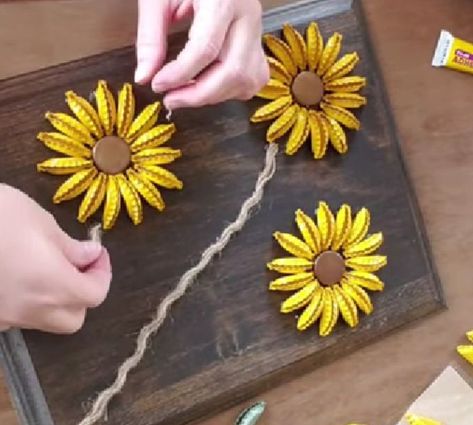 Diy Sunflower Wall Art, Bottlecap Flowers Diy, Bottle Cap Crafts Flowers, Sunflower Bottle Cap Art Diy, Beer Bottle Caps Crafts, Projects With Bottle Caps, Sunflower Gifts Ideas Diy, Diy Bottle Cap Projects, How To Make Bottle Cap Art