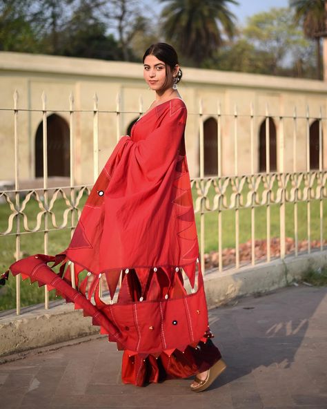 Unveil your vibrant side with the कुमकुम Saree! ❤️✨ Drenched in red, adorned with sparkling mirrors, playful ghungroos, and natural sea shell trims, this saree features an intricate slit design for a touch of modern elegance. Exclusively available at letssaveas.com with exciting offers for a limited time. Make it yours and dazzle at your next event! #KumkumSaree #EleganceRedefined 🔥🌊 Tassels Designs, Saree Tassels Designs, Saree Tassels, Simple Sarees, Saree Ideas, Saree Design, Fancy Blouse, Fancy Blouses, Fancy Blouse Designs