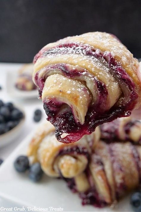 Blueberry Puff Pastry Braid This Blueberry Puff Pastry Braid is an easy yet elegant dessert that combines flaky, golden puff pastry with a sweet blueberry filling. Perfect for brunches, parties, or just a delicious snack! Ingredients: 1 sheet puff pastry (thawed) 1 cup fresh or frozen blueberries 2 tbsp granulated sugar 1 tbsp cornstarch 1 tsp lemon zest 1 tsp vanilla extract 1 egg (for egg wash) Powdered sugar for dusting (optional) Instructions: Preheat Oven: Preheat your oven to 400°F (2... French Puff Pastry Desserts, Puff Pastry Roll Ups, Blueberry Cream Cheese Puff Pastry, Pastry Roll Ups, Peach Cobbler Cheesecake Recipe, Berry Bars, Puff Pastry Ingredients, Cream Cheese Puffs, Puff Pastry Recipes Dessert