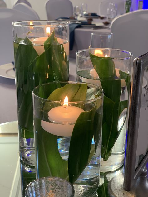 Tropical Wedding Centerpieces with floating candles Fish Bowl Candle Centerpiece, Floating Candle Tropical Centerpieces, Tropical Candle Centerpiece, Tropical Centerpieces Diy, Simple Tropical Centerpieces, Cylinder Centerpieces, Water Centerpieces, Mirror Centerpiece, Tropical Candles