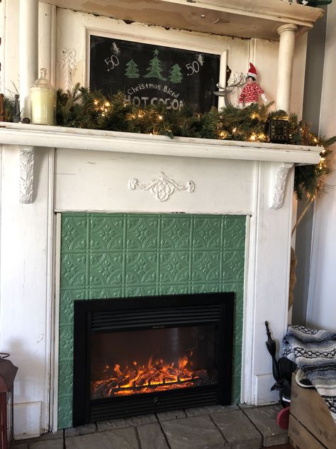 Painted faux tin tile painted vintage green fireplace surround. Tin Tile Fireplace Surround, Tin Fireplace Surround, Vintage Fireplace Tile, Vintage Tile Fireplace, Tin Tile Fireplace, Green Fireplace Tile, Vintage Fireplace Surround, Tiles For Fireplace, Vintage Fireplace Mantle