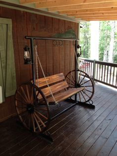 Porch swing with wagon wheel sides and working kerosene lanterns. Rustic Porch, Primitive Homes, Porch Furniture, House With Porch, Wagon Wheel, Western Decor, Repurposed Furniture, Upcycled Furniture, Rustic Furniture