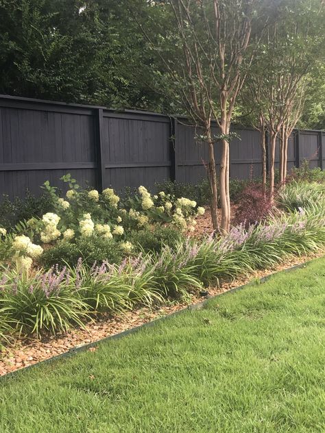 Gorgeous landscaping across the back fence, structured, zoysia sod Bushes As Fencing, Stained Fence, Sw Peppercorn, Peppercorn Paint, Zoysia Sod, Gorgeous Landscaping, Staining Wood Fence, Grey Fences, Garden Layouts