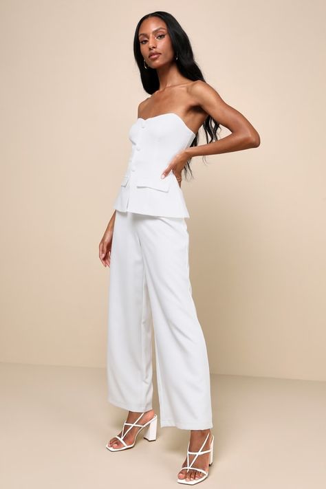 Step off cloud nine looking like a posh babe in the Lulus Sophisticated Angel White Strapless Vest Jumpsuit! Lightweight woven fabric shapes this ultra-chic jumpsuit with a strapless, sweetheart neckline (with hidden no-slip strips) and a vest-inspired bodice with decorative buttons, decorative flap pocket details, and a peplum-style silhouette. High, fitted waist sits atop straight pant legs that fall to ankle-length hems. Hidden back zipper/clasp. Fit: This garment fits true to size. Length: F