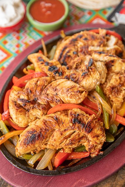 Easy Chicken Fajitas - SO much better than the Mexican restaurant and only 5 ingredients! We make these every week - great meal prep recipe! Chicken, Italian dressing, diced tomatoes and green chiles, taco seasoning and lime. Let the chicken marinate overnight and quickly cook in the skillet. Add onions and peppers for an authentic Mexican restaurant taste. SO easy and SO good! #mexican #chicken #chickenfajitas #mealprep Chicken Italian Dressing, Easy Chicken Fajita Recipe, Taco Seasoning Easy, Easy Fajita Recipe, Chicken Marinate, Chicken Italian, Slow Cooker Chicken Fajitas, Mexican Entrees, Easy Chicken Fajitas