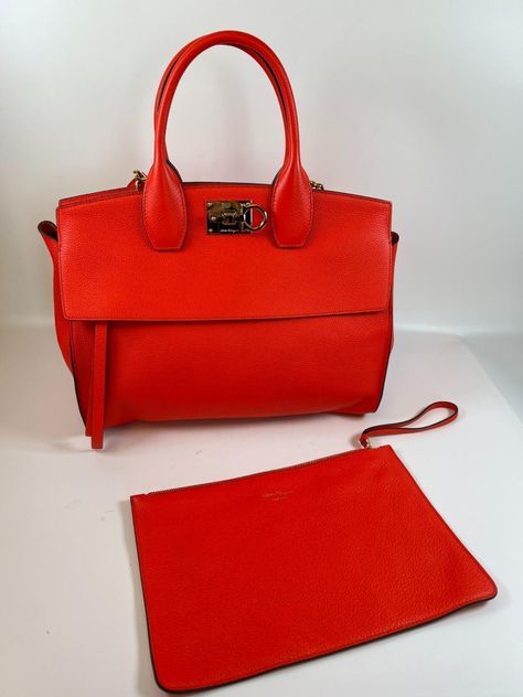 SALVATORE FERRAGAMO Bag STUDIO TOTE MEDIUM was £2400 red NEW w/o tags ref RP SALVATORE FERRAGAMO Bag STUDIO TOTE MEDIUM was £2400 red NEW w/o tags ref RP Description SALVATORE FERRAGAMO MEDIUM STUDIO TOTE was £2400 New without tags (though few light scratches to buckle) protective blue film still on base studs crafted from soft calf leather to give a slouchy silhouette, this bag comes with a signature Gancini buckle in refined gold tone. This spacious bag can be carried across the body, on the shoulder or handheld  zipped outer pocket detachable clutch comes with dustbag   Measurements of bag: 36 cms w x 29h x 14 cms deep   condition of bag:  New without tags Protective blue film still on base studs Minor scratches to gold hardware from being opened/closed before purchase pristine interior Ferragamo Bag, Salvatore Ferragamo Bags, Body On, Deep Conditioner, Film Stills, Salvatore Ferragamo, Gold Hardware, Calf Leather, Dust Bag