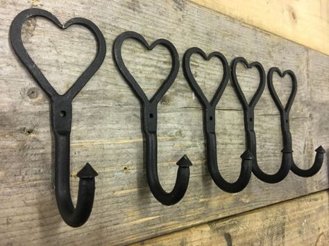 A lovely set of 5 wrought iron love heart hooks hand made in the forge from Wrought Iron. Both a decorative and practical sturdy hook, a great hook for the cloakroom, hallway, kitchen or bedroom. Sizes: Height: 130mm | Width: 70mm | Projection: 50mm Great price for quality! RRP: £7.95 Shabby Kitchen, Wall Entryway, Coat Pegs, Peg Hooks, Metal Craft, Forging Metal, Mason Jar Lighting, Hallway Kitchen, Jar Lights