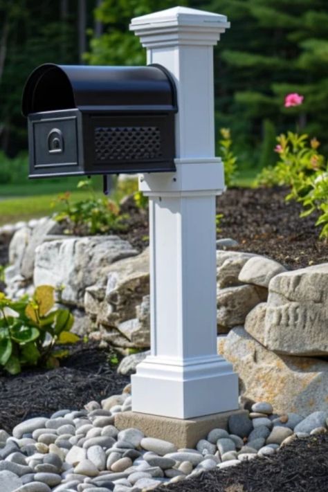 Elegant black mailbox mounted on a white post with a stone base, surrounded by landscaping pebbles and greenery. Mailbox Landscaping Ideas, Mailbox Landscape, Stone Mailbox, Small Porch Ideas, Mailbox Garden, Small Trellis, Mailbox Landscaping, Diy Mailbox, Mailbox Ideas