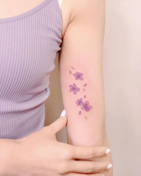 Simple Sakura Tattoo, Light Purple Tattoo, Japanese Wisteria Tattoo, Simple Cherry Blossom Tattoo, Cherry Blossom Tattoo Forearm, Seventeen Inspired Tattoos, Purple Tattoo Ideas, Cherry Blossom Tattoo Minimalist, Lilac Tattoos