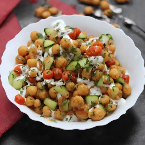 With so many chaat varieties available, this aloo chana chaat recipe tastes delicious and is quite simple to prepare. The tanginess of the tamarind chutney and the sweetness of the tomatoes complement the cooked chickpeas well. All of the flavours complement one another perfectly, making it the ideal side dish for any Indian buffet. This […] The post Chana Chaat appeared first on Scrumptiously. Aloo Chana, Indian Buffet, Chana Chaat Recipe, Cooked Chickpeas, Uk Food, Tamarind Chutney, Pani Puri, Chaat Recipe, Chickpea Salad