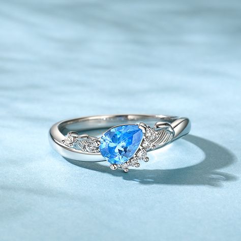 This sterling silver ring, adorned with the essence of the ocean, captures the essence of tranquility and majesty. At its heart lies an ocean blue pear-shaped stone, shimmering with a subtle wave pattern. This unique cut stone appears to be a frozen wave, capturing the essence of the sea's movement in a single moment. The ring's design is inspired by the undulating waves that lap against the shore, each curve and contour mimicking the graceful dance of the sea. The sterling silver band is sleek Ocean Wave Ring, Ocean Wedding Ring, Ocean Engagement Ring, Weding Rings, Waves Jewelry, Ocean Ring, Waves Design, Wave Jewelry, Ocean Inspired Jewelry