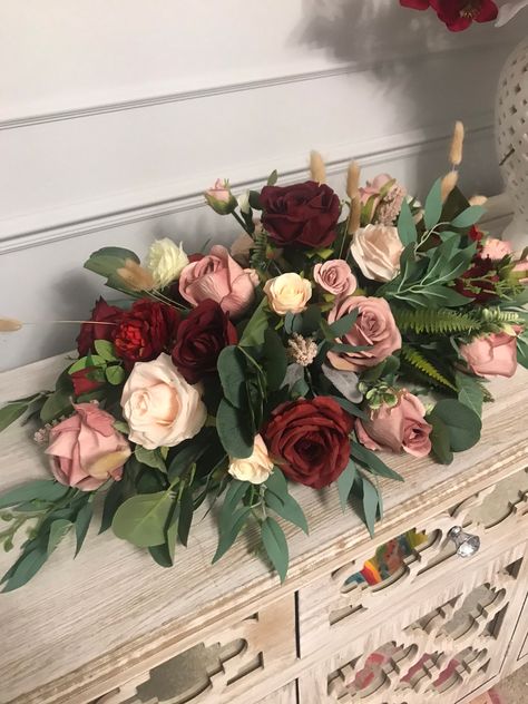 Elevate your event with our Pink and Red Long Head Table Flower Centerpiece. Handmade with the utmost care, this stunning centerpiece features a timeless blend of silk roses, lush foliage, and delicate bunny tails. 🌸 WHAT IS IT? This exquisite 3ft-long flower centerpiece is the perfect choice for dressing up your head table, creating a captivating focal point for weddings, parties, or special occasions. It can also be placed in urns or on the floor for added versatility. 🌷 PREMIUM QUALITY: Cra Mulberry Wedding Table Decor, Flower Bouquet Table Decoration, Wedding Burgundy Decoration, Long Low Flower Arrangement, Round Table Flower Arrangements, Wreath Centerpiece Wedding, Long Table Flower Arrangements, Long Table Centrepiece, Long Head Table