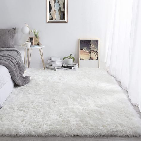 Supremely soft and wonderfully warm, this area rug is sure to create an enchanting environment in your home. The cloud-bright white faux sheepskin is luminous and luxurious, decadent underfoot and completely cruelty-free. White Fluffy Rug, Fuzzy Rug, Faux Fur Area Rug, Faux Sheepskin Rug, Carpets For Kids, Area Rug For Living Room, Faux Fur Rug, Fur Rug, Fluffy Rug