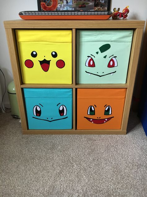 Ikea Kallax unit with Drona boxes and felt “first partner” Pokemon faces applied with heat n bond.. Pokemon Man Cave, Pokemon Furniture Diy, Pokemon Room Decor Ideas, Pokemon Mural Bedroom, Pokemon Nursery Ideas, Pokemon Theme Bedroom, Pokemon Organization Ideas, Pokémon Theme Room, Kids Pokemon Bedroom