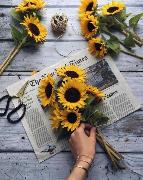 Beautiful sunflowers wrapped in old newspapers. Newspaper, Flowers