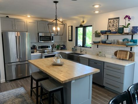 Our cabinets are Tiverton gray shaker style from Costco. Our countertops are quartz. The island is butcher block from Lowes. Our floors are Jamestown oak vinyl plank also from Costco. Granite Countertops Butcher Block Island, Grey Island With Butcher Block, Butcher Block Island Quartz Counters, Butcher Block Countertops With Grey Floors, Quartz Countertops With Butcher Block Island, Grey Cabinets With Butcher Block Counter, Butcher Block And Granite Countertops, Gray Cabinets With Butcher Block Counter, Quartz And Butcher Block Countertops