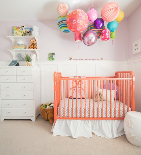 This nursery takes mobiles to the next level with tons of brightly colored paper lanterns and—yup, you’re seeing that right—a disco ball. We’re betting baby will never be bored in this crib. To finish the look, refresh an older crib with a splash of bright coral. Disco Nursery, Transitional Nursery, Modern Nursery Design, Peach Echo, Eclectic Nursery, Contemporary Nursery, Colorful Nursery, Girl Nursery Themes