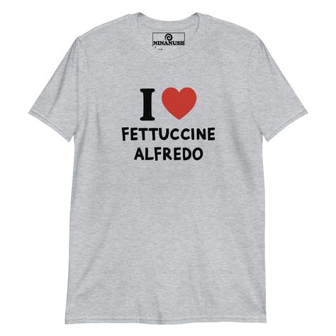 The I love fettuccine Alfredo t-shirt! A classic t-shirt for pasta lovers that stands out and makes a bold statement. Wear this funny foodie shirt and show off your fettuccine passion. It's a soft and comfortable tee, designed for fettuccine Alfredo enthusiasts and made just for you. This quirky shirt is the perfect unique graphic tee to add some personality to your outfits or a funny gift for a fellow fettuccine Alfredo lover.    * 100% ring-spun cotton  * Dark Heather is 65% polyester, 35% cot Foodie Outfit, Quirky T Shirts, Pickled Garlic, Fettuccine Alfredo, Weird Holidays, Happy Design, Funny Graphic Tees, Baked Beans, Kids Swimwear