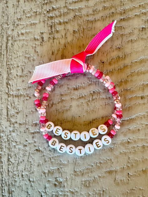 "Besties Friendship Bracelet Set for you and your BFF. Celebrate friendship with this matching set of pink stretch beaded friendship bracelets. Handmade gift for best friends, galentines, valentines, and bffs. Valentine's Day gift idea. Word bracelet. Bracelets will be made to the standard women's length of 7\". If you need a larger or smaller sizes please use the personalization box. High quality, durable, USA made elastic stretch cord. Tips to care for your bracelets: * Store gently * Always roll bracelets on rather than stretching * Avoid excessive water" Braclet Ideas Valentines, Bestie Valentines Day Ideas, Friendship Bracelets Valentines, Galentines Friendship Bracelets, Valentine’s Day Friendship Bracelet, Valentines Beaded Bracelet Ideas, Valentines Day Notes For Friends, Bestie Valentine Gifts, Valentine Friendship Bracelet