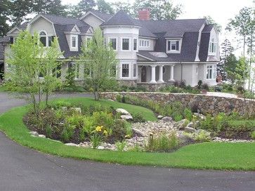 Feature Friday: An approachable approach to a casual landscape Circle Driveway Landscaping, Stone Entrance, Circle Driveway, Rock Landscape, Gambrel Roof, Driveway Landscaping, Circular Driveway, Front Yards, Easy Landscaping