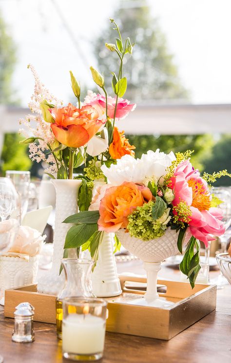 Mismatched Vintage Milk Glass Vase Centerpieces |  Mismatched Vintage Milk Glass Vase Centerpieces  FAVORITE      Fb2c404e 124c 11e4 843f 22000aa61a3e~rs 729 Centerpieces consisted of collected mismatched milk glass vases scattered on a lace runner with coral peonies, peach garden roses, ranunculus, craspedia and sprigs of other flowers.  FROM A WHIMSICAL, CHIC BARN WEDDING AT THE WINVIAN IN LITCHFIELD, CONNECTICUT Wedding Centerpieces Vases, Centerpieces Vases, Milk Glass Centerpiece, Milk Glass Wedding, Milk Glass Decor, Glass Vases Centerpieces, Vintage Centerpieces, Gold Color Palettes, Milk Glass Vase