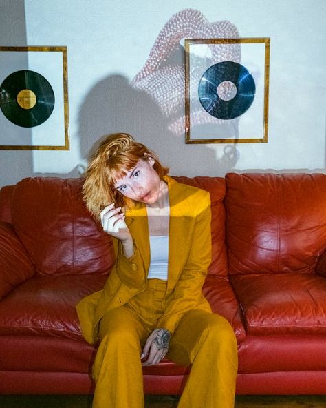 Woman in Brown Long Sleeve Shirt Sitting on Red Leather Couch · Free Stock Photo Studio Couch Photoshoot, Red Couch Photoshoot, Leather Couch Photoshoot, Velvet Couch Photoshoot, Couch Photoshoot, Vintage Sofa Photoshoot, Antique Couch Photoshoot, Moody People, Red Leather Couches