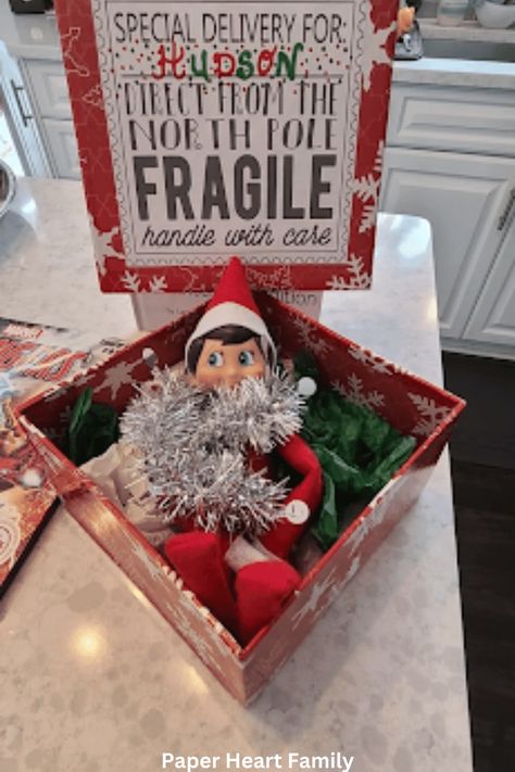 38 Fantastic Elf on the Shelf Arrival Ideas Elf In The Shelf Arrival Ideas, Elf Shelf Arrival, Elf Is Back Ideas, Simple Thanksgiving Table Decor, Napkin Folding Ideas, Fireplace Tv Wall Decor, Elf On The Shelf Arrival, Paper Napkin Folding, Elf Ideas Easy