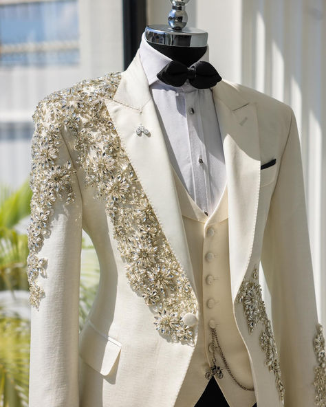 An Ivory White, knitted, horizontal spiral floral pattered, peak lapel tuxedo suit, glass Swarovski stones detailing, tux pant & diamond shaped bow tie. Diamond Suit Men, Wedding Dresses Man, Ivory Tuxedo Wedding, Prom Suit Ideas, White Tuxedo Men, Tuxedo Peak Lapel, Prom Outfits For Guys, Ivory Tuxedo, Peak Lapel Tuxedo