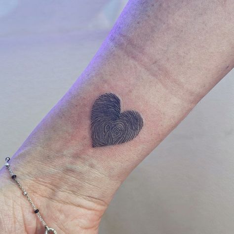 Fingerprints of the closest people in a heart-shaped tattoo💜 #tattoodublin Thumb Print Heart Tattoo Placement, Tattoo Heart Fingerprint, Thumbprint Heart Tattoo Placement, Finger Print Love Heart Tattoo, Heart Shape Fingerprint Tattoo, Fingerprint Heart Tattoos, Tattoo Dublin, Fingerprint Tattoos, Heart Tattoo Wrist