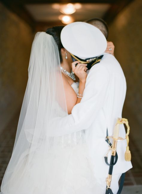 My groom a US Navy Officer in his dress whites and me in my Lazaro wedding dress and cathedral length veil stealing a kiss behind his hat (cover). Navy Engagement Photos, Us Navy Officer, Navy Couple, Usmc Wedding, Lazaro Wedding Dress, Army Wedding, The Office Wedding, Marine Wedding, White Winter Wedding