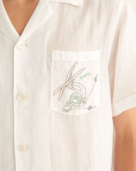 This shirt is inspired by a scarf from the midcentury, which was printed with tumbling skiers. We reproduced the motifs in delicate, single-thread embroidery. The shirt is made of lightweight linen and has picot detaling along the hem. 100% linen Made in India Dry clean only View all shirts Sava is 6'1" and wearing a s Bode Embroidery, Bode Shirt, Closet Edit, Emily Adams, Luxury Menswear, Beauty Gift Card, Mens Luxury Fashion, Thread Embroidery, Silhouette Crafts