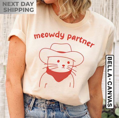 Meowdy Partner T-Shirt | Cat Lover Gift | Funny Meme Shirt, Cowboy Cat Shirt, Kitty Tee, Country Western Top, Funny Cat Owner Clothing Gift Meowdy Partner, Western Top, Western Tops, Cat Tee, Cat Owner, Top Funny, Cat Shirt, Cat Lover Gift, Roll Up Sleeves