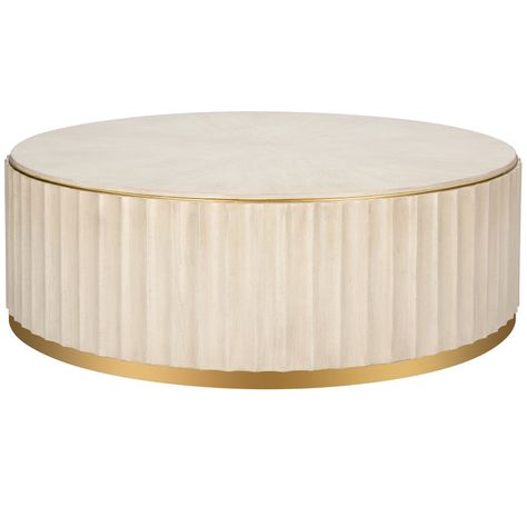 The Fluted Round Brass Base Coffee Table is a study in refined simplicity. A low round drum shape features a bleached wood vertical fluted detail around the body. A brass plinth base and edging around the tabletop add elegance. #contemporary, #coffeetable Ivory Round Coffee Table, Neoclassical Coffee Table, Cream Coffee Table, Round Drum Coffee Table, French Country Coffee Table, Shadow Box Coffee Table, Coffee Table Metal Frame, Elegant Outdoor Furniture, Painted Coffee Tables