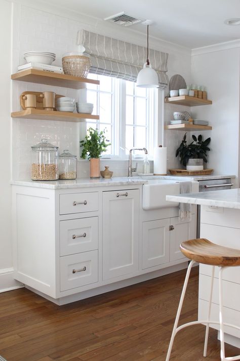 We love Caitlin's bright white kitchen with warm wood shelves with perfect items they use everyday. #openshelving #whitekitchen #farmsink Small White Kitchen Decor, White With Wood Kitchen, Small Bright Kitchen, Cute White Kitchen, Cozy White Kitchen, All White Kitchen Ideas, Small Kitchen White, Small White Kitchen Ideas, Wood White Kitchen