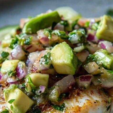 Chef zouheir on Instagram: "Coconut Lime Fish with Avocado Salsa 🐟🥥🍋🥑
Ingredients 🥗
For the Coconut Lime Fish:

4 white fish fillets (such as cod, tilapia, or snapper) 🐟
Salt and pepper to taste 🧂
Zest of 1 lime 🍋
Juice of 2 limes 🍋
1/2 cup coconut milk 🥥
2 tablespoons olive oil 🫒
2 cloves garlic, minced 🧄
1/4 teaspoon red pepper flakes (optional) 🌶️
Fresh cilantro, chopped (for garnish) 🌿
For the Avocado Salsa:

1 large avocado, diced 🥑
1/2 cup cherry tomatoes, quartered 🍅
1/4 cup red onion, finely diced 🧅
Juice of 1 lime 🍋
Salt and pepper to taste 🧂
Fresh cilantro, chopped 🌿
Instructions 📜
Marinate the Fish:

In a shallow dish, combine lime zest, lime juice, coconut milk, olive oil, minced garlic, red pepper flakes, salt, and pepper. Add the fish fillets to the marin Coconut Lime Fish With Avocado Salsa, Juice Coconut, Fish Dinner Recipes, Salsa Ingredients, Seafood Entrees, Fish Fillets, Lime Salt, Skillet Cooking, Shake Off