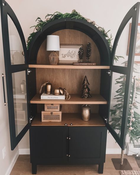 Winter cabinet styling 🌲 ❄️ I’ve had so much fun getting out all my winter/Christmas decor the last few days. I also added a new beautiful piece to this cabinet that I shared yesterday so check that reel out!!🫶🏻🔔 This black cabinet is back in stock! Comment shop for the cabinet link. For all other links head to my LTK (link in bio!) #winterstyling #cabinetstyle #archedcabinet #christmasdecor #christmas #holidaydecor #wintervibes Black Cabinet Decor, Cabinet Styling, Winter Christmas Decor, Arched Cabinet, Black Cabinet, Cabinet Style, Black Cabinets, Cabinet Decor, Back In Stock