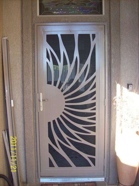 I just love how this security screen door looks like part of a flower or the sun. My husband and I are planning on installing a security screen door since we've had some break-ins in the neighborhood. Since I still want my home to look beautiful, we will have to find one like this since it has a beautiful pattern on it. Fancy Gate, Security Screen Doors, Front Door Security, Steel Screen, Security Screen Door, Steel Security Doors, Grill Gate Design, Welcome Signs Front Door, Metal Doors Design