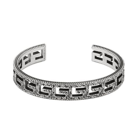 A chunky bangle design from Italian fashion house Gucci  Crafted from the finest sterling silver  Finished with a blackened aureco silver process for adding an aged look  Can be stacked with other Gucci G-Cube creations  Featuring the square G motif repeated along the bangle  Geometric pattern reminiscent of Gucci’s 70’s designs  Gucci jewellery is handcrafted and made in Italy  Approved genuine Gucci official stockist for guaranteed authenticity Chunky Silver Bracelet, Square Bracelet, Gucci Bracelet, Ladies Bangles, Designer Silver Jewellery, Gucci Jewelry, Sterling Silver Cuff Bracelet, Fine Jewelry Bracelets, Hand Jewelry