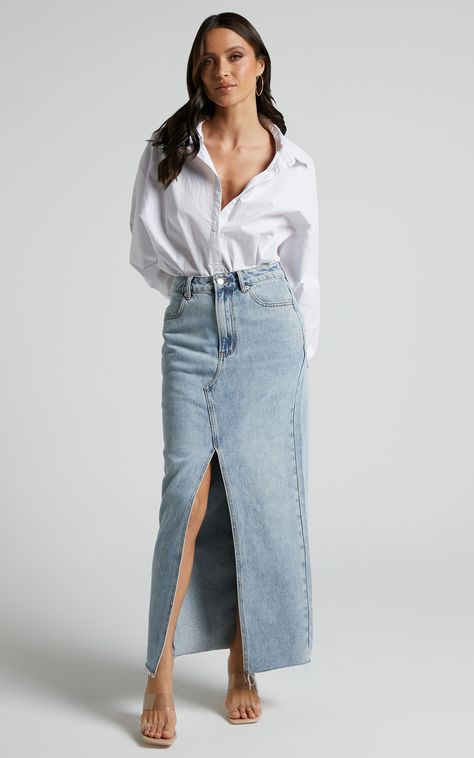 Get ready to turn heads with the Kira Skirt - Denim Maxi Skirt With Front Split In Light Blue Wash. This trendy denim skirt is perfect for any casual occasion or weekend activity. The light blue wash adds a fresh and modern touch, while the front split detail gives it an edgy twist.Made from high-quality denim, this pencil skirt will hug your curves in all the right places, making you feel confident and stylish. Whether you pair it with a cute crop top or a cozy sweater, the Kira Skirt is sure t Denim Split Skirt Outfit, Long Blue Jean Skirt Outfits Fall, Denim On Denim Women, Light Denim Skirt Outfit, Light Blue Skirt Outfit, Light Blue Top Outfit, Blue Denim Skirt Outfit, Denim Maxi Skirt Outfit, Split Denim Skirt