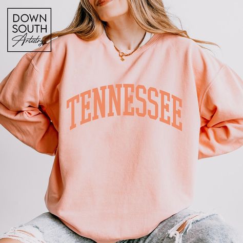 Lightweight crewneck sweatshirt featuring a classic Tennessee arch across the chest in collegiate lettering. SIZE & FABRICATION * 100% ring-spun cotton, lightweight, garment dyed * Unisex Adult Sizing - Comfort Colors brand * Check out the product photos for a specific sizing chart for this style * Please note this is a unisex style meaning it is not a fitted ladies style. If you would like a fitted look I recommend sizing down. * Lay your favorite shirt at home flat and measure armpit to armpit to compare to the size chart in the photos PRINT * This is a direct-to-garment printed item which is printed INTO the fabric, not sitting on top of it, creating a soft hand-feel WASHING INSTRUCTIONS * Wash inside out, in cold water, on gentle cycle. Tumble dry low or let air dry * Do not use fabric College Student Gifts, Comfort Colors Sweatshirt, College Gifts, Boho Green, Student Gift, Down South, Professional Look, College Student, Student Gifts