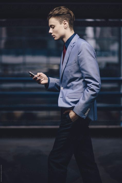 A Young Businessman Walking And Looking At His Cell Phone | Stocksy United Checking Phone Pose, Looking At Phone Reference, Hand In Pocket Reference, Guy On Phone, Hands In Pockets Pose, Man Holding Phone, Phone Reference, Hand In Pocket, Walking Poses