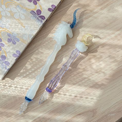 Introducing the Mystic Unicorn Glass Dip Pen, our Dreamscape series' latest creation. Inspired by a unicorn's ethereal beauty, it features a white shaft, detailed head, flowing mane, and a glowing blue horn. Elevate your writing with this enchanting pen 🦄🌙 Tap @komorebistationery to see more beautiful Japanese glass pens. #glassdippen #glassdippenart #glassdippens #goldfishjunkie #goldfishlover #japanesestationery #DreamscapeSeries #MysticUnicornPen #FantasyWriting Japanese Stationery Store, Mythical Unicorn, Skeletal Structure, Unicorn Glass, Glass Dip Pen, Pen Journal, Pen Brands, Ink In Water, Japanese Stationery