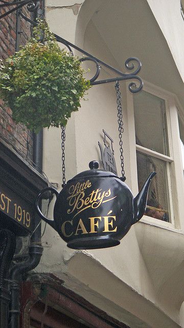 "Little Betty's" Cafe rounded black teapot sign.  Gift Shop Magazine  www.giftshopmag.com Teapot Decorations, Cafe Sign, Yorkshire Uk, Trade Sign, Pub Signs, Shop Fronts, Cafe Shop, Store Signs, Display Design