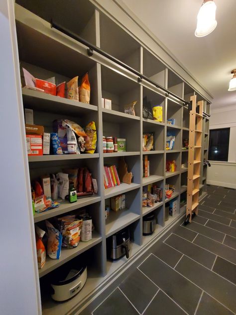 Custom home pantry storage Pantry With Ladder Design, Library Ladder Pantry, Pantry With Library Ladder, Pantry With Ladder, Larder Shelving, Pantry Ladder, Pantry Addition, Space Breakfast, Laundry Room Pantry