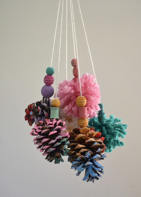 Kids make mobiles from painted pinecones and homemade pom-poms. Tent Event, Pom Pom Mobile, Mobile Craft, Painted Pinecones, Lamb Decorations, Cones Crafts, Pine Cone Crafts, Easter Bunny Decorations, Camping Crafts