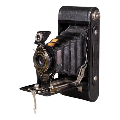 ABOUT    An original "No. 2 Folding Pocket Brownie" camera with leather wrapped body, brass and chrome accents. Autographic film window in back with iron stylus for writing notes directly on the film.      CREATOR Eastman Kodak Company, New York.     DATE OF MANUFACTURE c.1909.     MATERIALS AND TECHNIQUES Leather, Chrome, Optical Glass, Fabric.     CONDITION Good. Wear consistent with age and use. Some flaking of the bellows but appear to be intact.     DIMENSIONS H 3.5 in. W 6.5 in. D 8 in.  H New York Date, Brownie Camera, Folding Camera, Writing Notes, Classic Camera, Old Cameras, Black Tears, Photos Originales, Rochester Ny