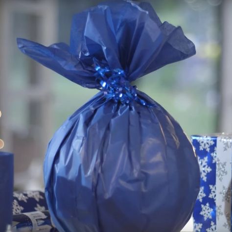 Watch How to Wrap One of the Most Difficult Gifts Ever How To Wrap A Ball Present, How To Gift Wrap A Ball, How To Wrap A Baseball Hat For A Gift, How To Wrap A Basketball, How To Wrap A Ball Gift, How To Wrap A Ball, How To Wrap Round Shaped Gifts, Gift Rap, Holiday Hacks