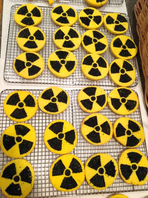 I made some yummy radioactive cream cheese cut out cookies for my Hubbies Godzilla themed birthday. I got an image of the radioactive symbol from the internet and made a stencil from an old plastic lid from a deli container. It is the same kind of plastic lid that is on coffee cans. I kept the lip of the lid up so the sugar wouldn't spill off of the lid. I lightly pressed the plastic stencil into the dough and rubbed the sanded sugar into the cookie dough then baked. Radioactive Theme Party, Radioactive Party Ideas, Kaiju Party Ideas, Godzilla Themed Food, Xenomorph Birthday Party, Radioactive Party, Fallout Wedding, Fallout Birthday, Radiology Graduation