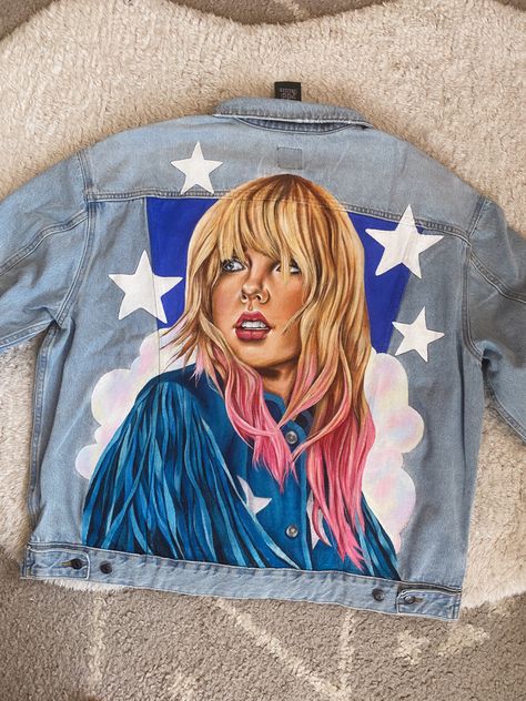 Hand painted denim jacket featuring lover era Taylor Swift #taylorswift #taylorswiftedit #taylornation #erastouroutfit #erastour #erastourfit Eras Tour Denim Jacket, Taylor Swift Denim Jacket, Taylor Swift Jean Jacket, Jean Jacket Diy, Light Jean Jacket, Bedazzled Jeans, Taylor Swift Merchandise, Taylor Swift Legs, Taylor Swift Street Style